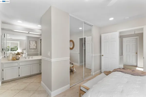 a bedroom with a bed and a large mirror