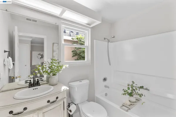 a bathroom with a sink toilet a mirror and shower