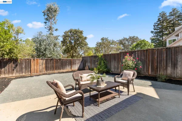 a backyard of a house with table and chairs