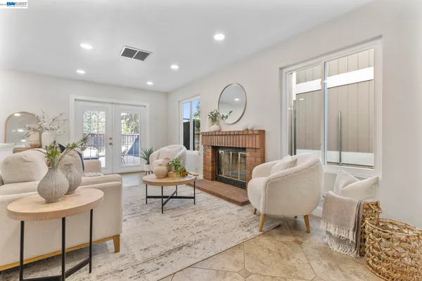 a living room with furniture a fireplace and a table