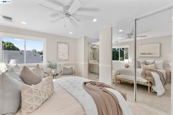 a bedroom with furniture and a large window