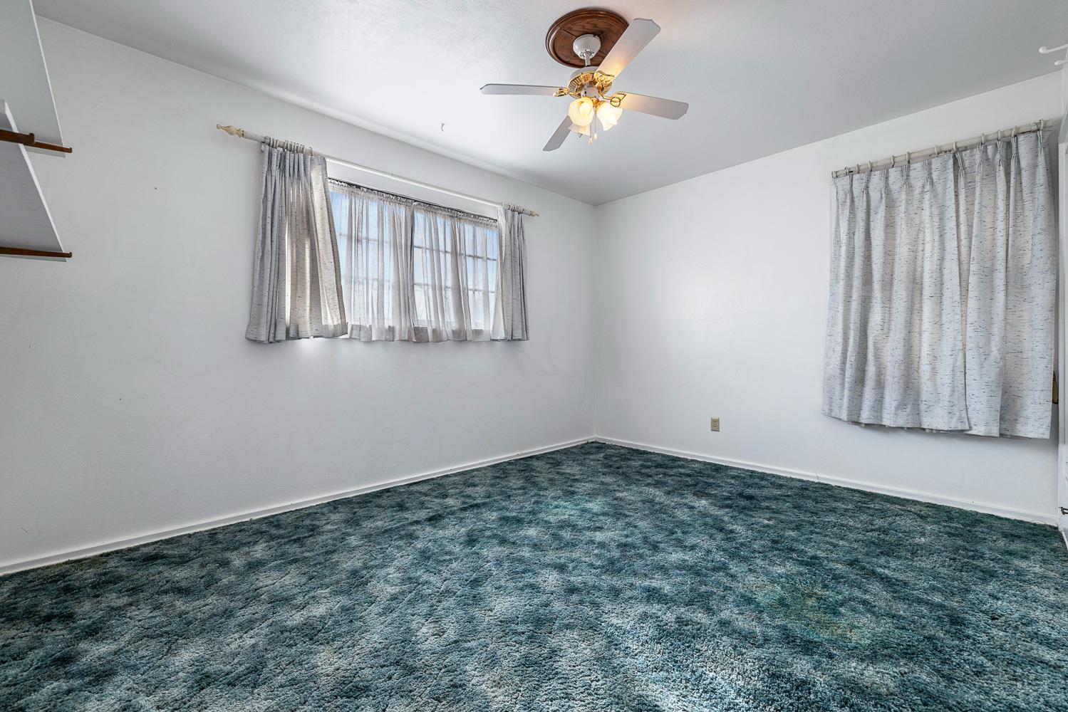 183 Harrison Street Coalinga, CA 93210 - Photo 30 of 45 an empty room with windows and fan