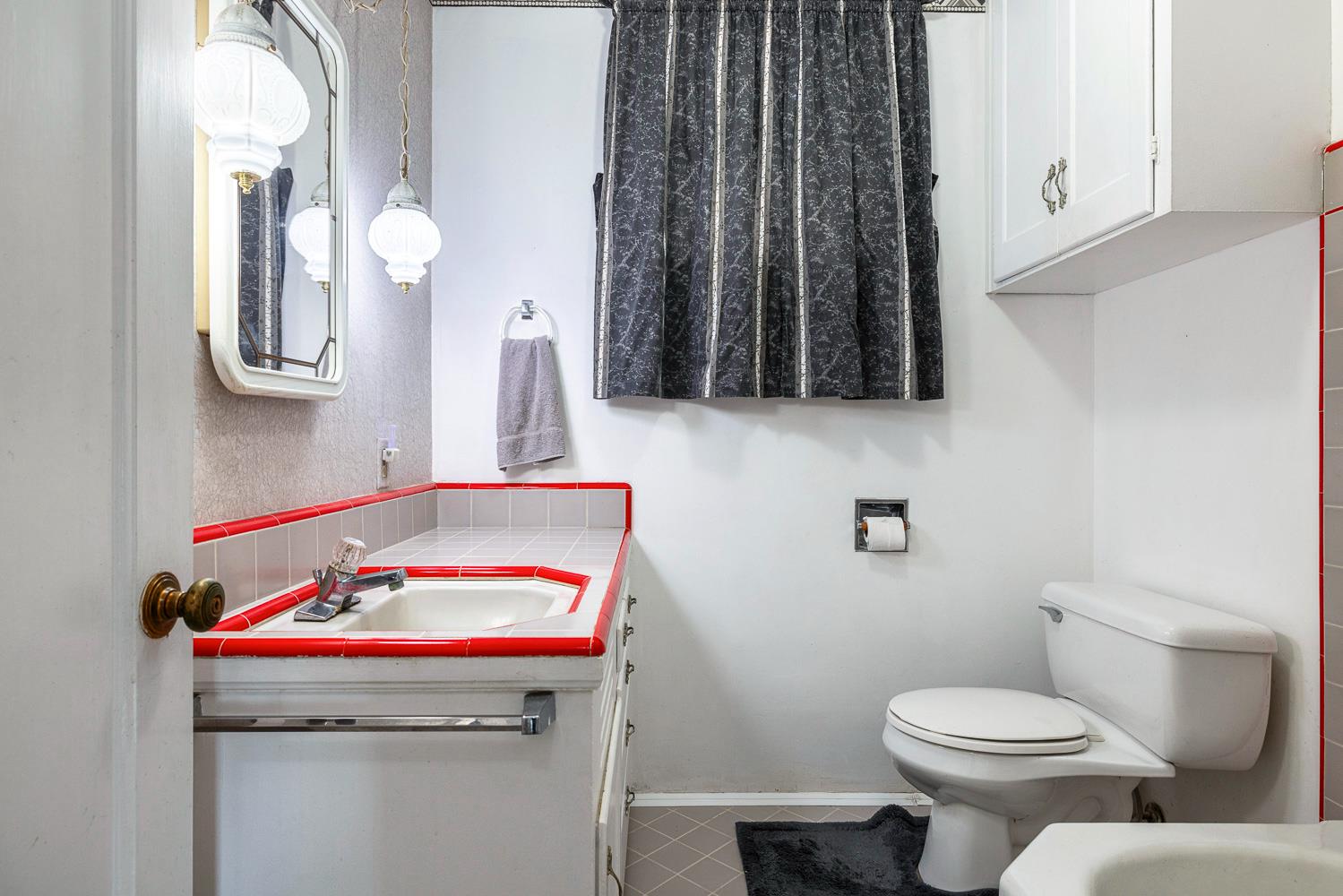 183 Harrison Street Coalinga, CA 93210 - Photo 33 of 45 a bathroom with a toilet a sink and a window