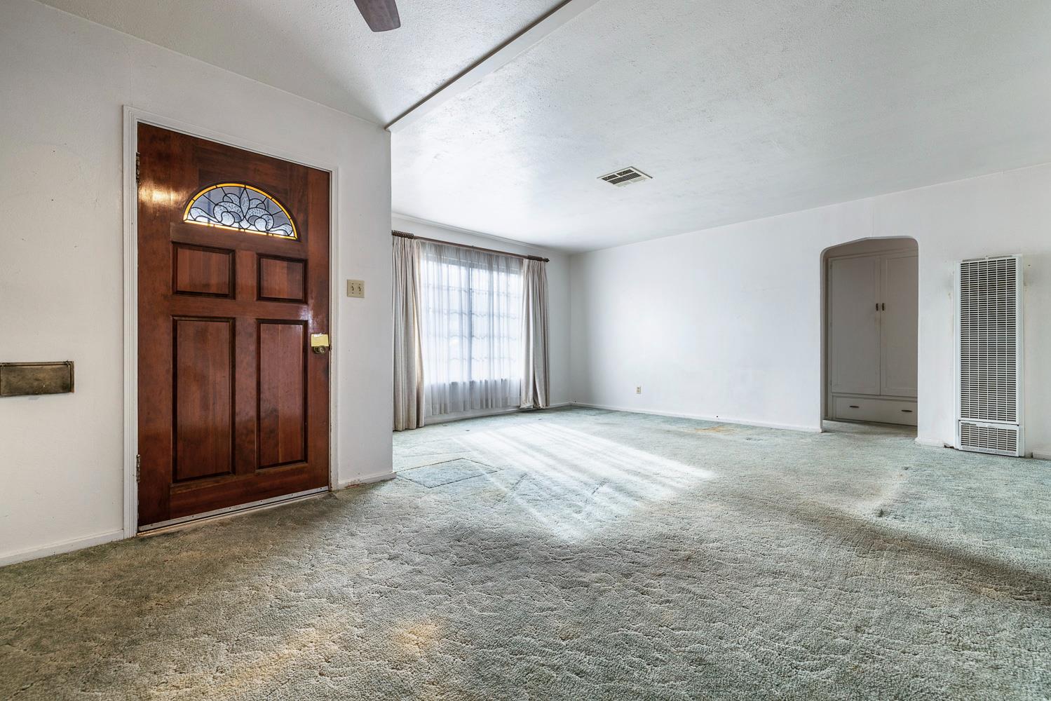 183 Harrison Street Coalinga, CA 93210 - Photo 7 of 45 an empty room with windows and cabinet