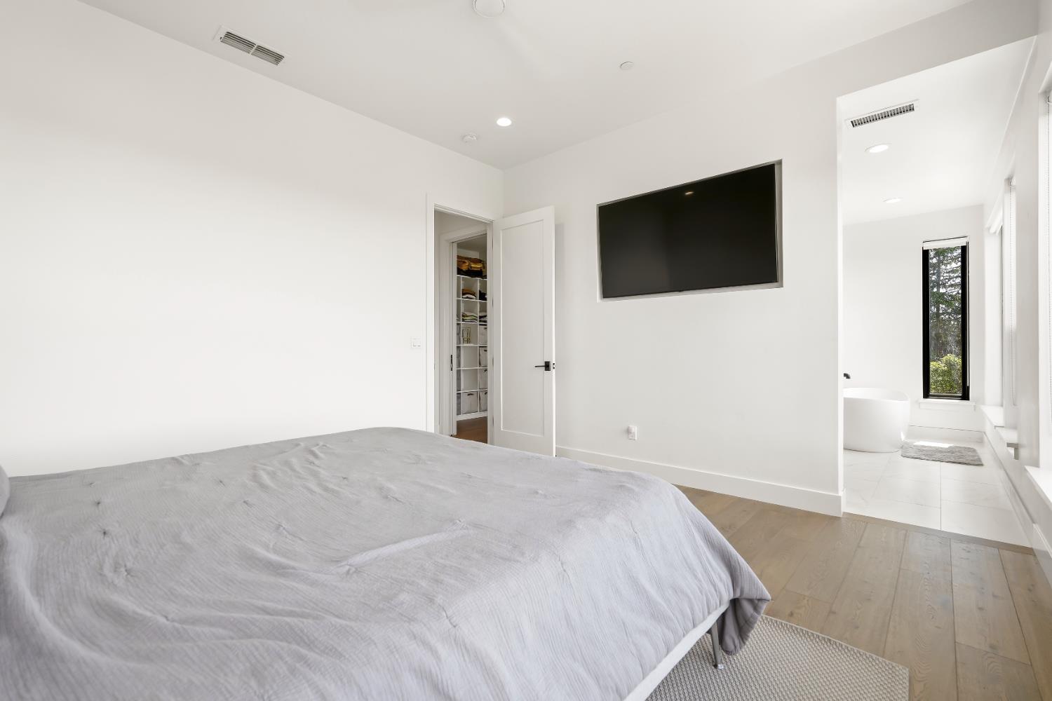 2661 Shirland Tract Road Auburn, CA 95603 - Photo 39 of 87 a spacious bedroom with a bed and a flat screen tv