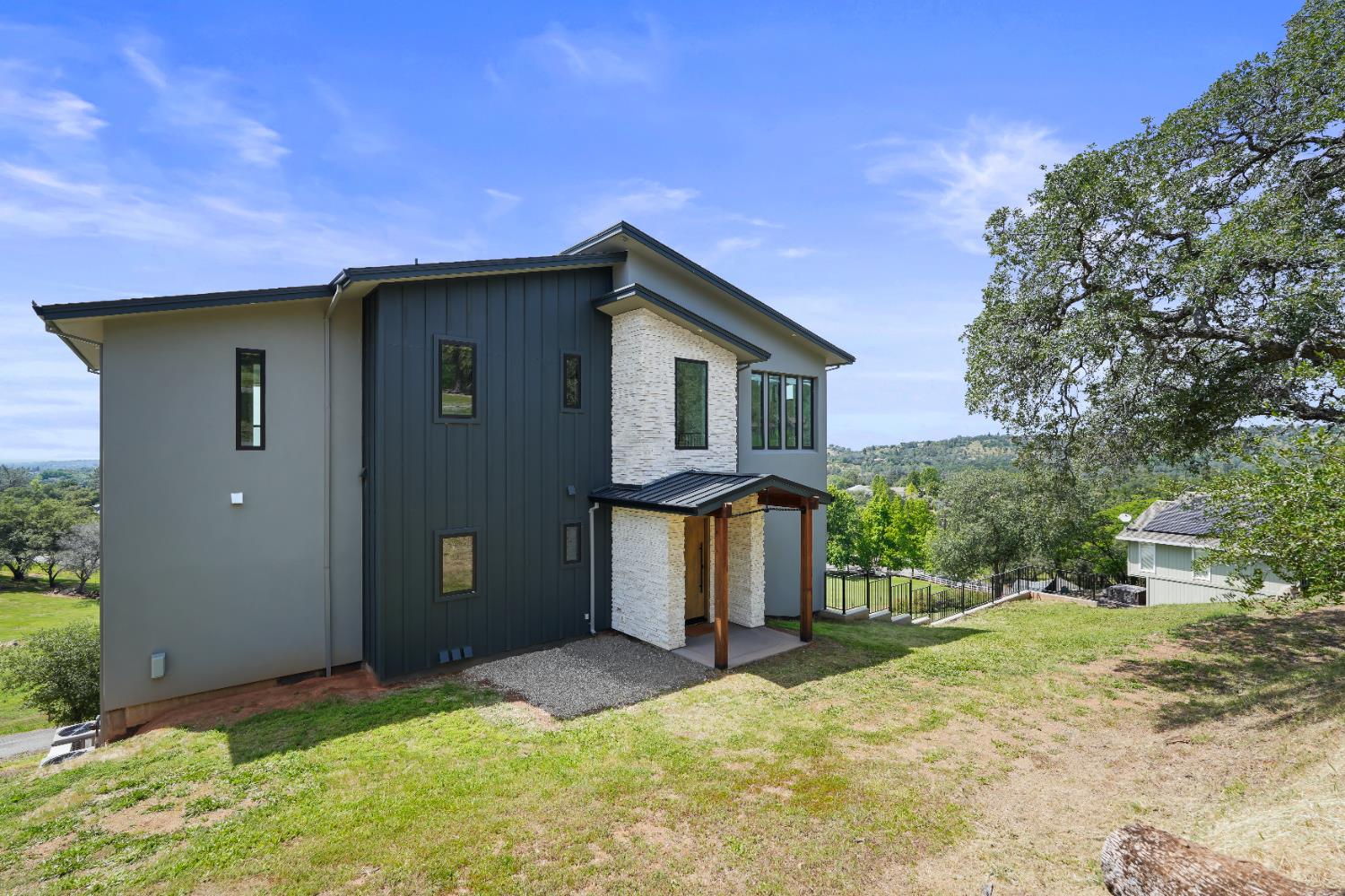 2661 Shirland Tract Road Auburn, CA 95603 - Photo 6 of 87 a front view of a house with a yard and garage
