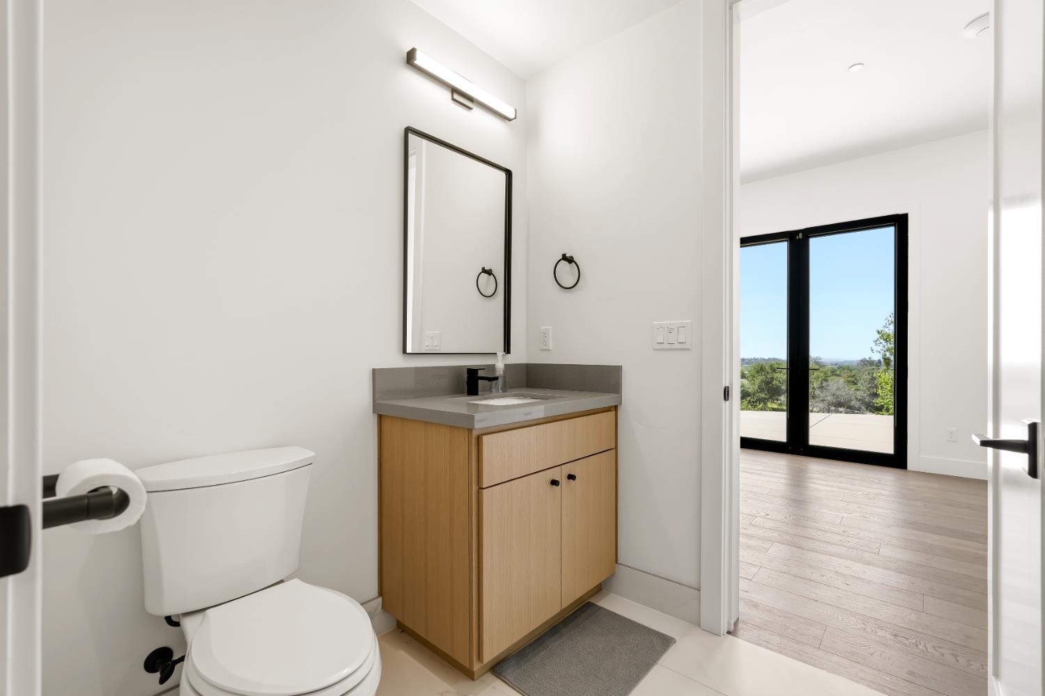2661 Shirland Tract Road Auburn, CA 95603 - Photo 67 of 87 a bathroom with a toilet a sink and mirror