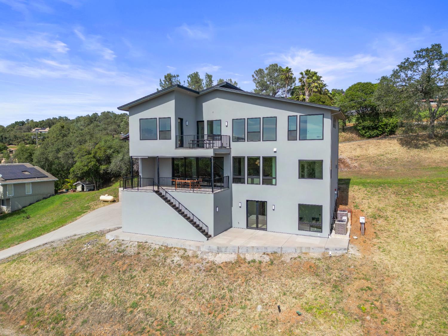 2661 Shirland Tract Road Auburn, CA 95603 - Photo 76 of 87 a view of a white house with a yard plants and large tree