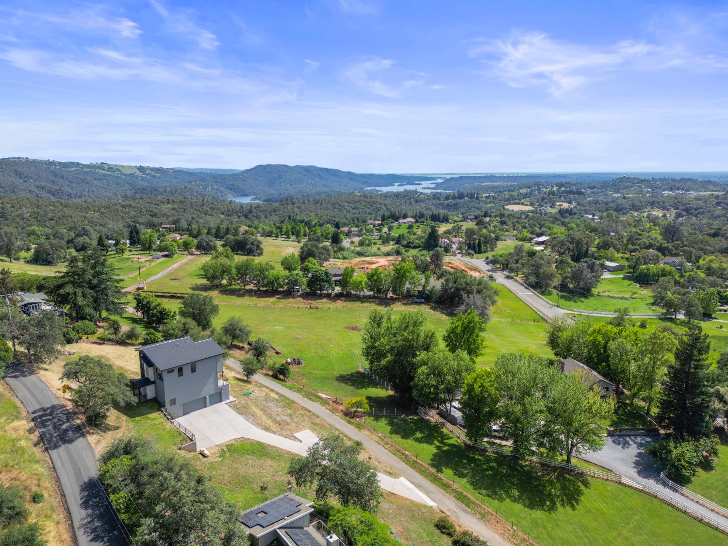 2661 Shirland Tract Road Auburn, CA 95603 - Photo 79 of 87 an aerial view of a house with a garden and lake view