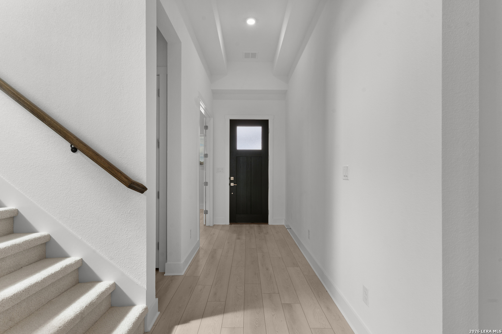 940 Nolte Bend Seguin, TX 78155 - Photo 3 of 19 a view of a hallway with wooden floor and staircase