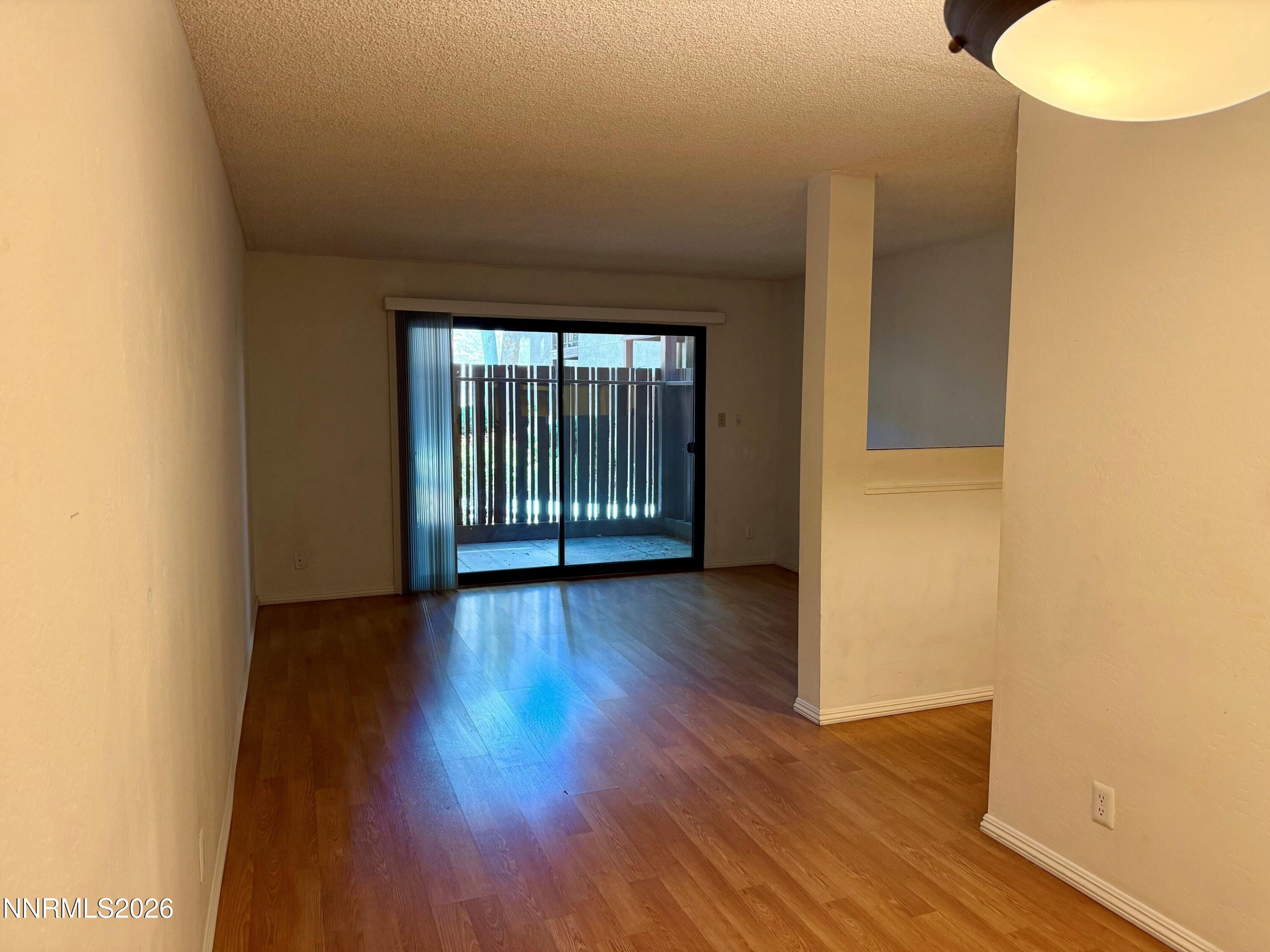 2955 Lakeside Drive, Unit 120 Reno, NV 89509 - Photo 13 of 21 an empty room with wooden floor and windows