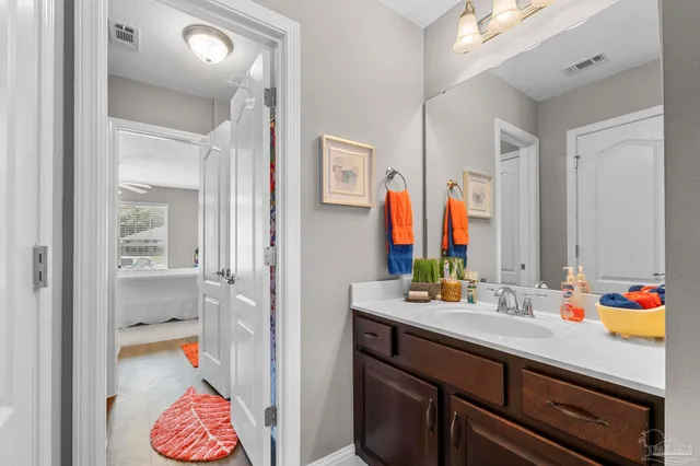 a bedroom with a bed and painting on the wall