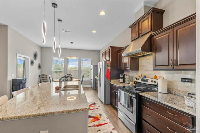 a living room with kitchen island furniture and a chandelier