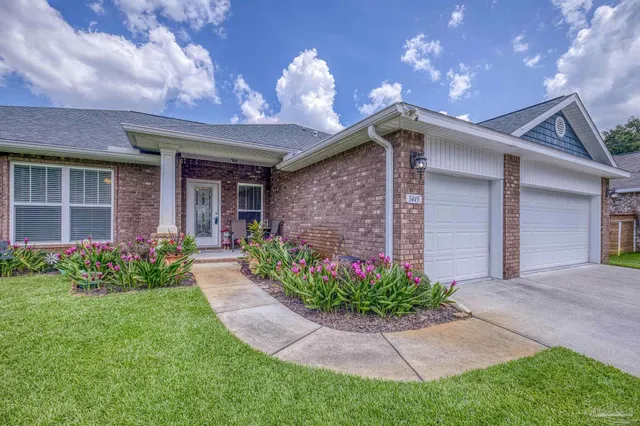 a front view of a house with a garden