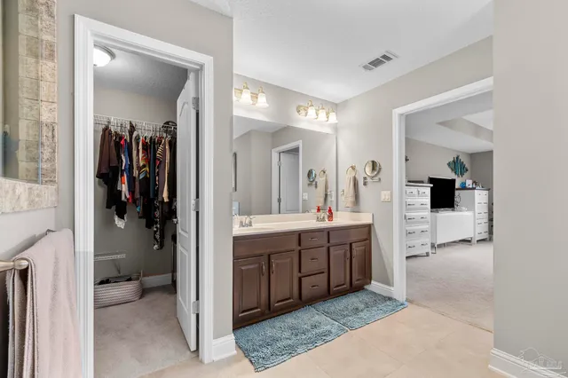 a view of a house with a big yard potted plants and large tree