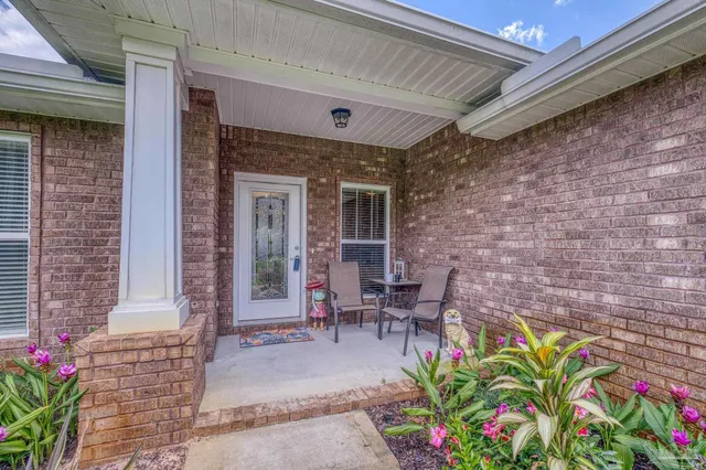 a view of a patio with table and chairs and potted plants