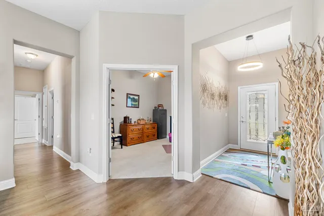 a view of a hallway view with wooden floor and front door