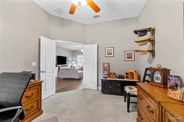 a view of a workspace with furniture and a window