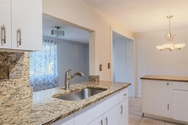 a close view of a sink a faucet and appliance in the kitchen