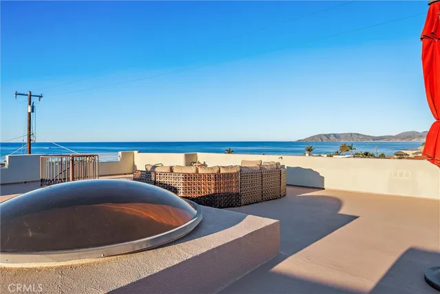 a living room filled with furniture and a kitchen view