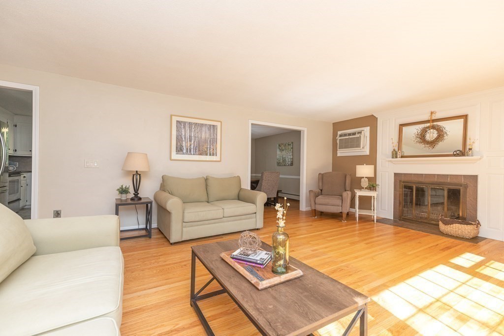113 Franklin Road Longmeadow, MA 01106 - Photo 6 of 36 a living room with furniture a fireplace and a flat screen tv