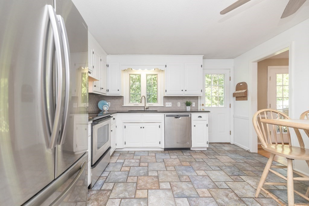 113 Franklin Road Longmeadow, MA 01106 - Photo 8 of 36 a kitchen with a stove a sink dishwasher a refrigerator and cabinets with wooden floor