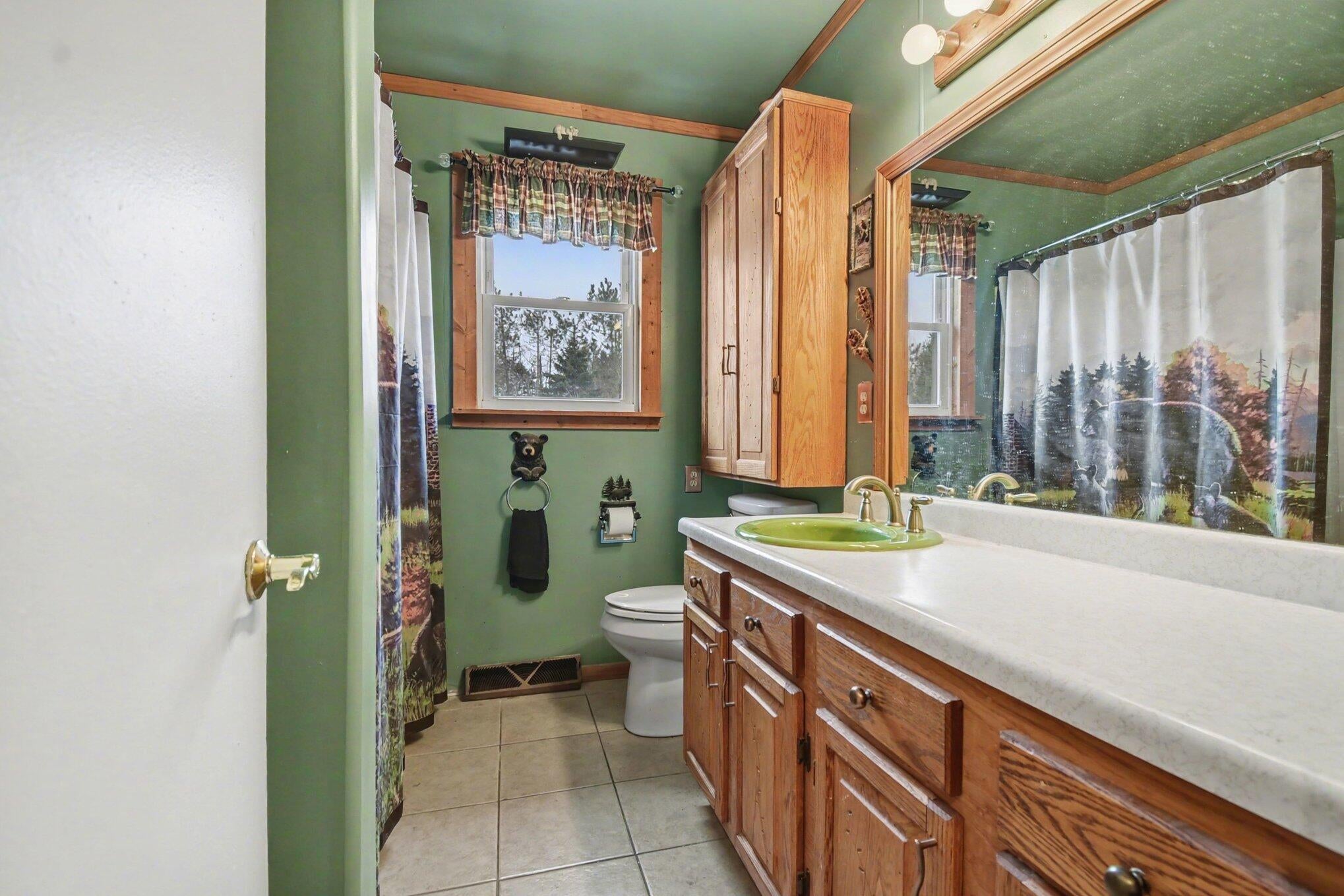 3821 Allis Road Gaylord, MI 49735 - Photo 6 of 25 Custom maple cabinet and updated shower fixtures.