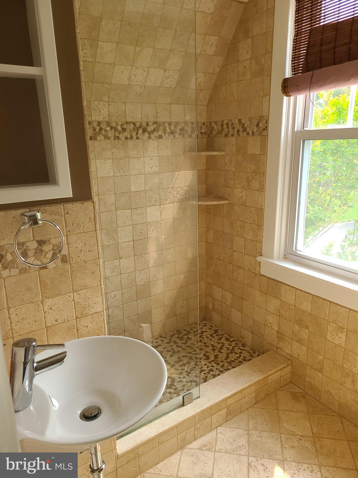 1700 Goodview Road Parkville, MD 21234 - Photo 24 of 50 a bathroom with a sink a window and a shower