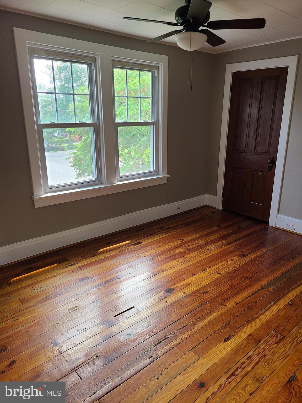 1700 Goodview Road Parkville, MD 21234 - Photo 28 of 50 a view of an empty room with wooden floor and a window