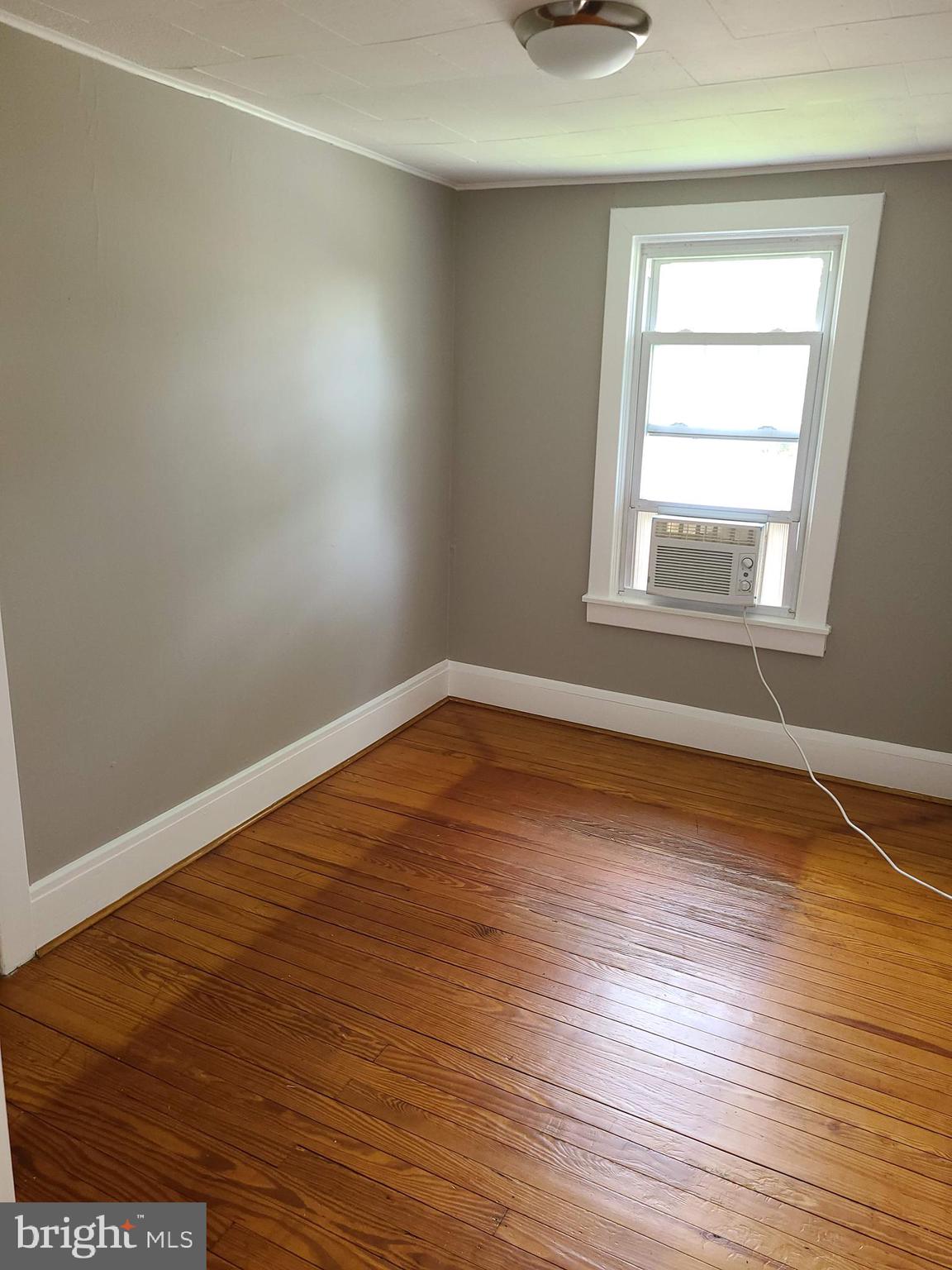 1700 Goodview Road Parkville, MD 21234 - Photo 29 of 50 an empty room with wooden floor and windows
