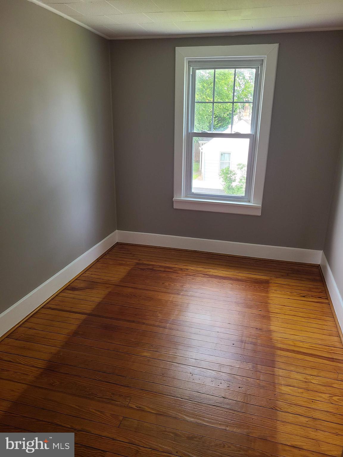 1700 Goodview Road Parkville, MD 21234 - Photo 31 of 50 an empty room with wooden floor and windows