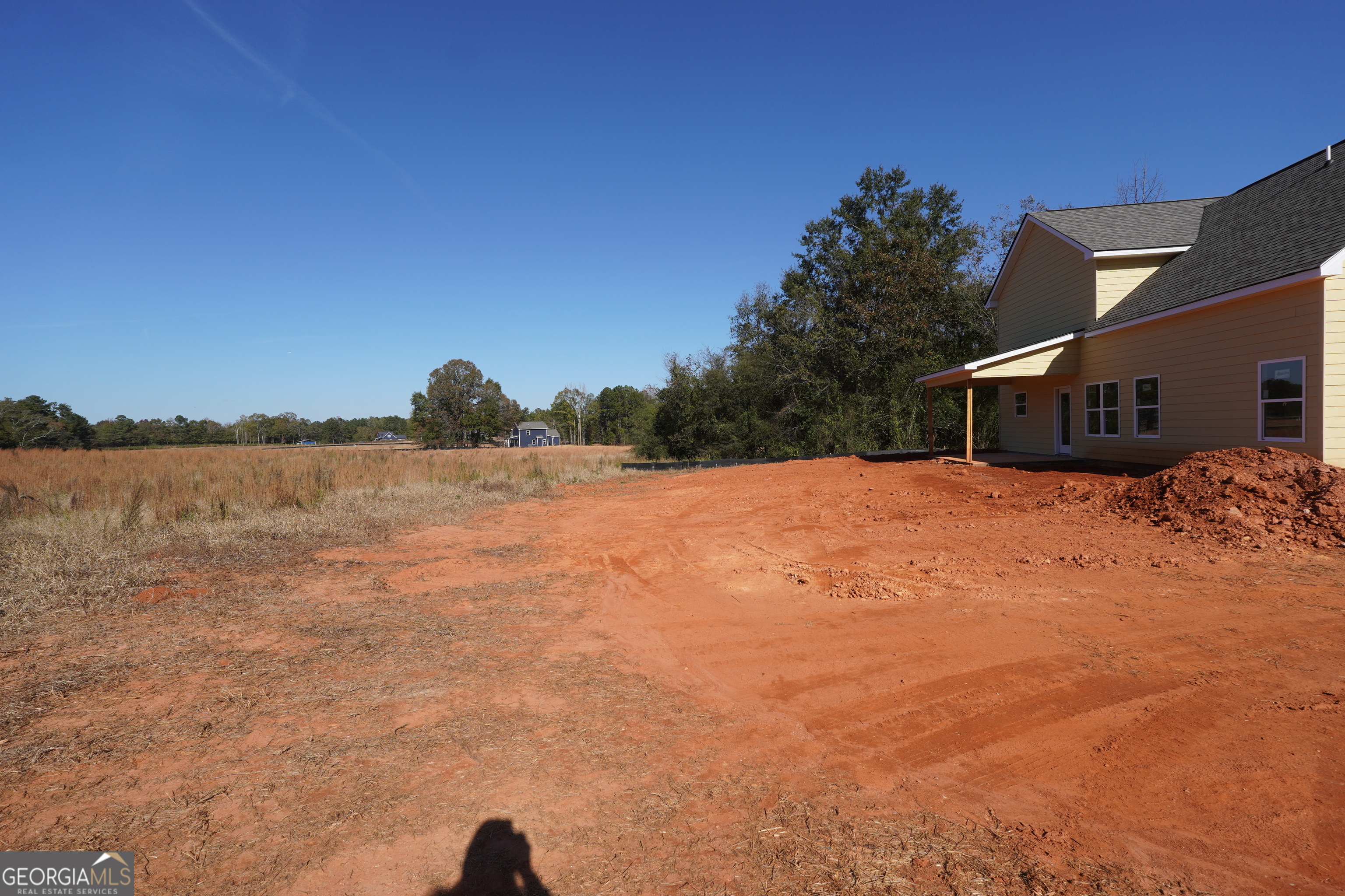 59 Oak Road Locust Grove, GA 30248 - Photo 11 of 13 a view of a lake with a house in the background