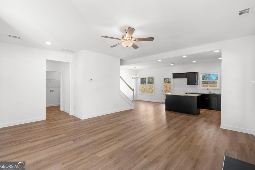 59 Oak Road Locust Grove, GA 30248 - Photo 12 of 38 a view of a kitchen with a sink a refrigerator and a stove top oven