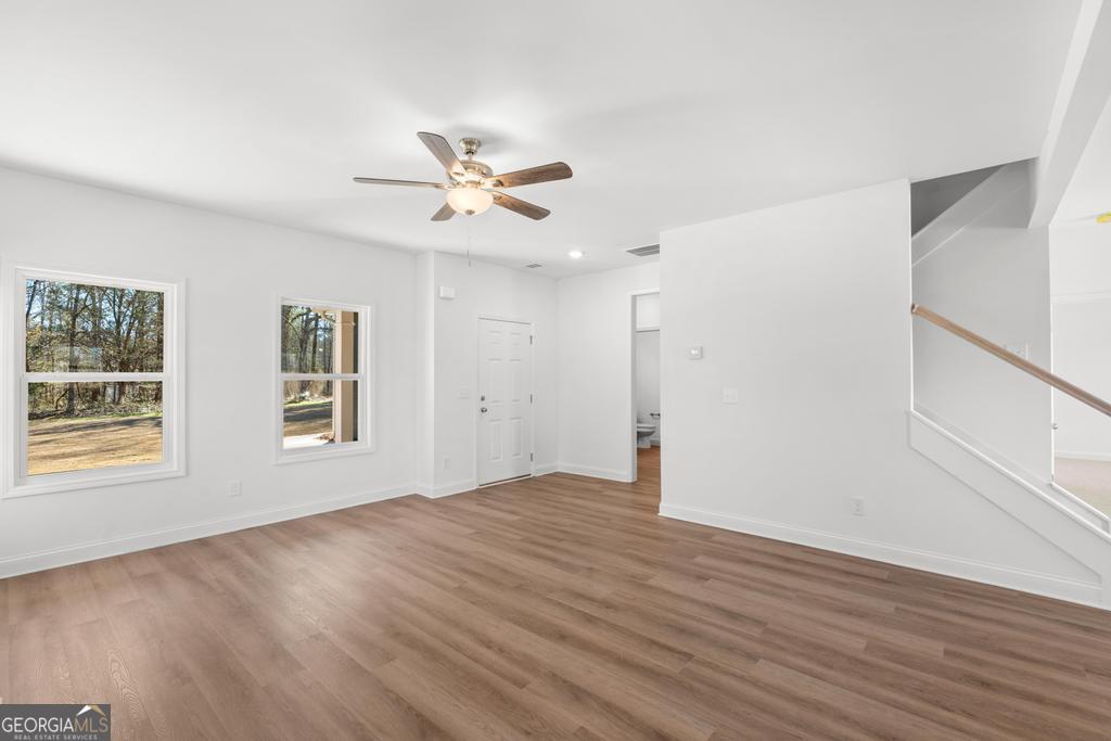 59 Oak Road Locust Grove, GA 30248 - Photo 13 of 38 a view of empty room with wooden floor and fan