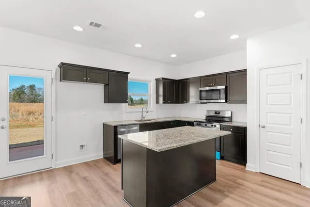 a kitchen with a sink stove and cabinets