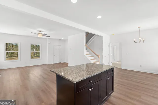 an empty room with wooden floor and window