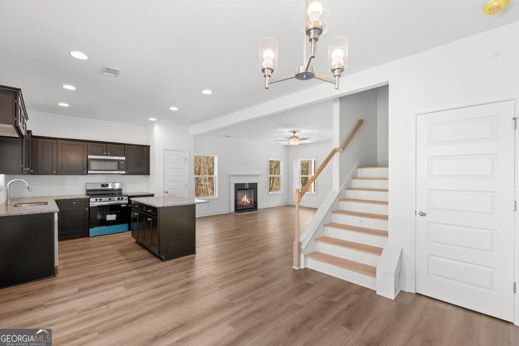 59 Oak Road Locust Grove, GA 30248 - Photo 19 of 38 a view of kitchen with microwave stove refrigerator and wooden floor