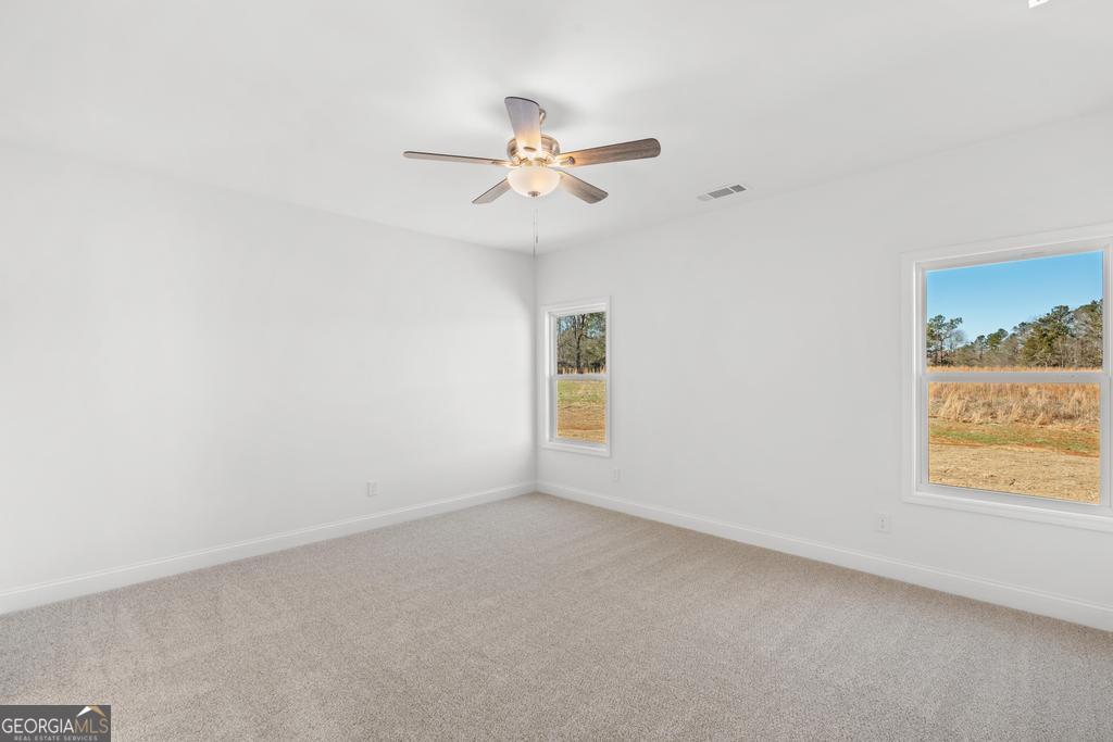 59 Oak Road Locust Grove, GA 30248 - Photo 20 of 38 an empty room with a window and a fan