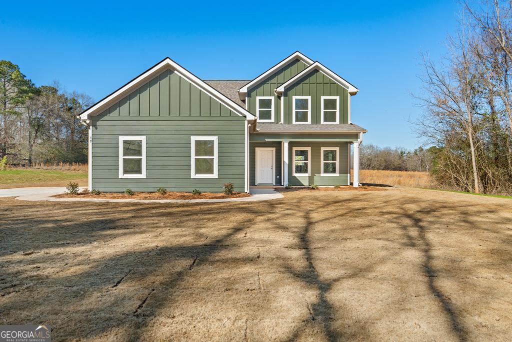 59 Oak Road Locust Grove, GA 30248 - Photo 2 of 38 a front view of a house with a yard