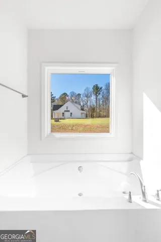 a bathroom with a painting on the wall
