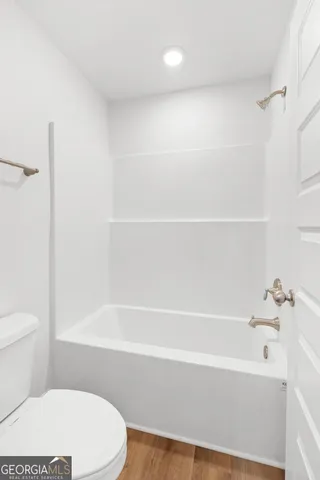 a bathroom with a bathtub and a toilet