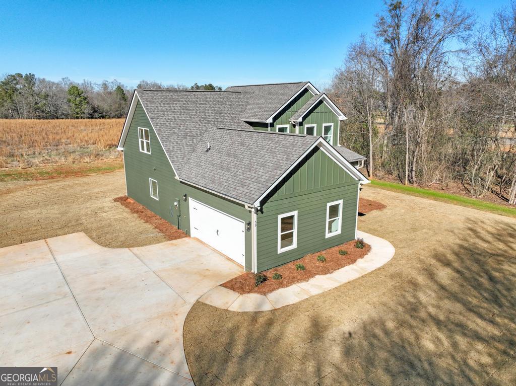 59 Oak Road Locust Grove, GA 30248 - Photo 4 of 38 a view of house with yard and trees in the background