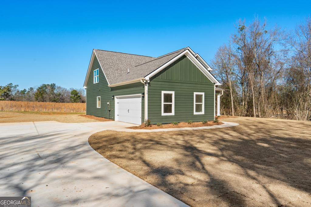 59 Oak Road Locust Grove, GA 30248 - Photo 5 of 38 a view of a house with backyard and trees