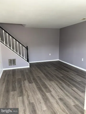 a view of an entryway with wooden floor
