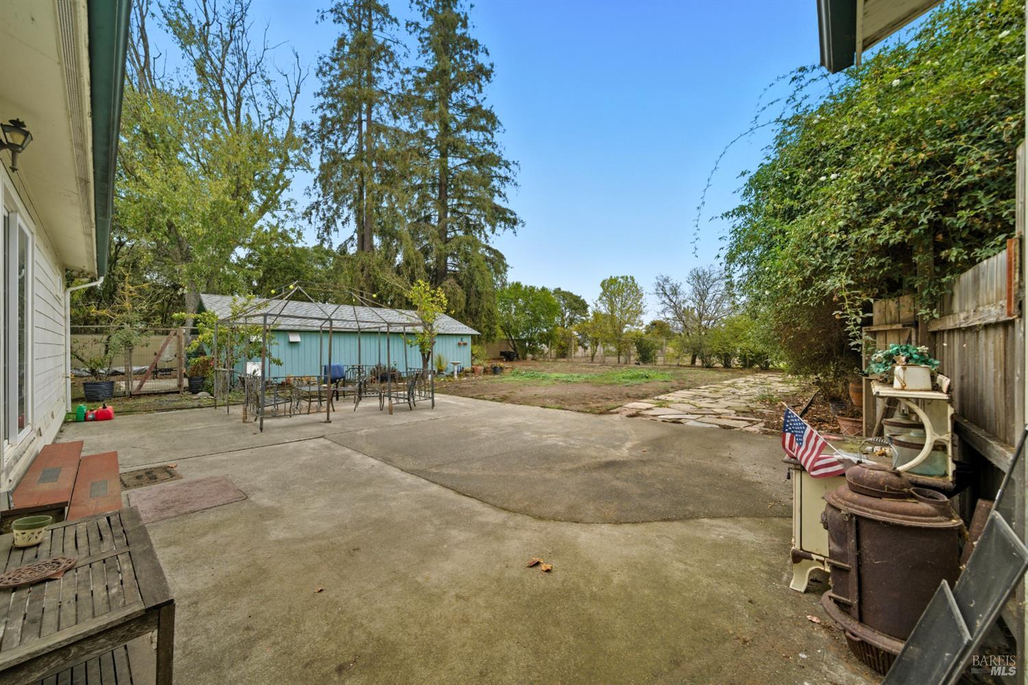 3960 Llano Road Santa Rosa, CA 95407 - Photo 14 of 52 a view of a patio with table and chairs and potted plants