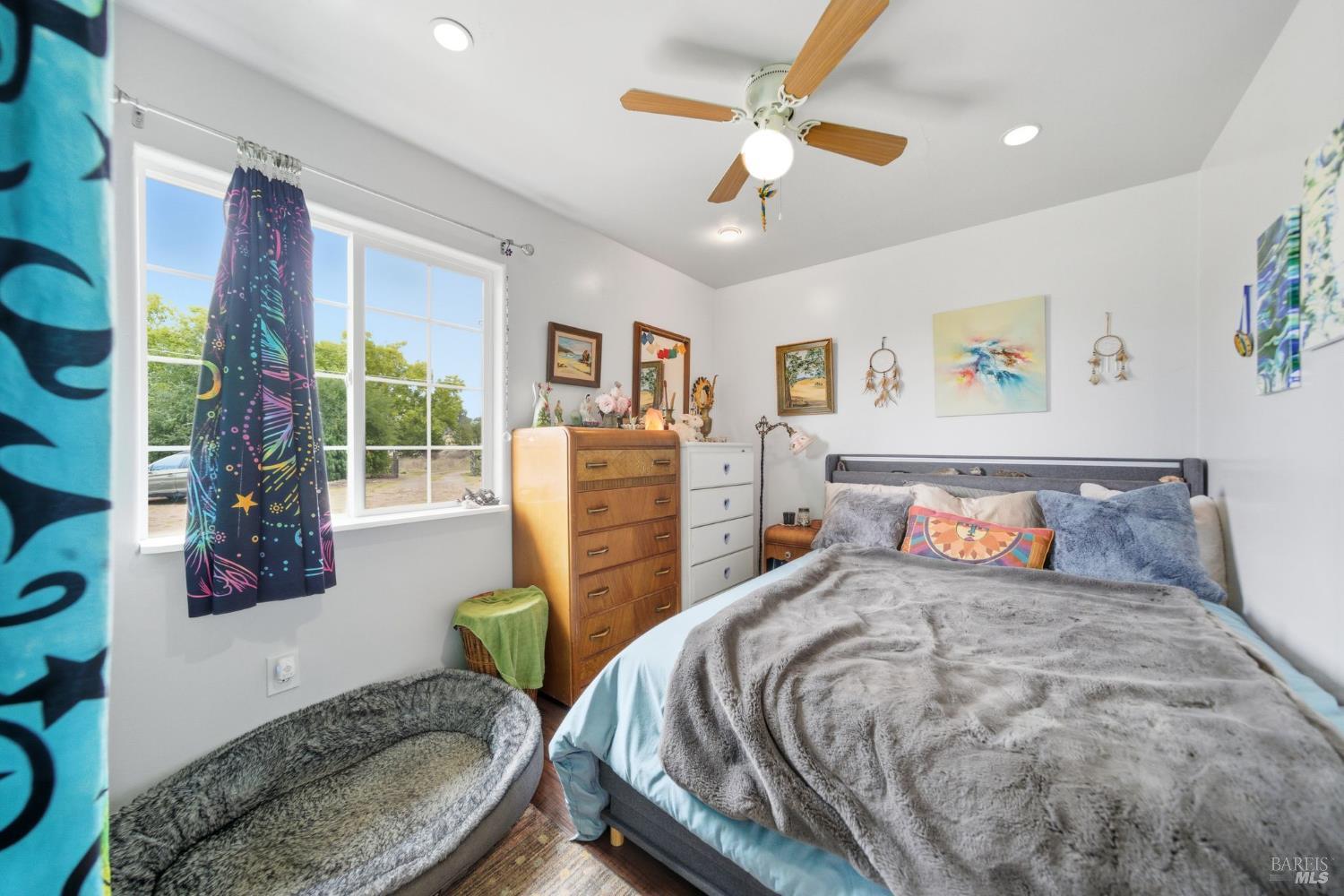 3960 Llano Road Santa Rosa, CA 95407 - Photo 23 of 52 a bedroom with a bed and a chandelier