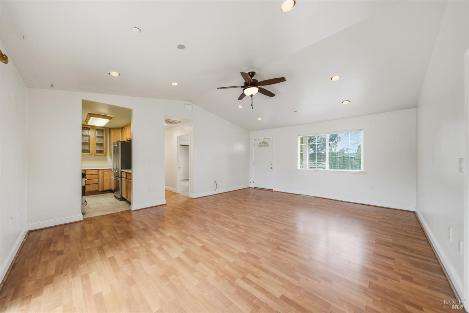 3960 Llano Road Santa Rosa, CA 95407 - Photo 4 of 52 a view of an empty room with a window and wooden floor