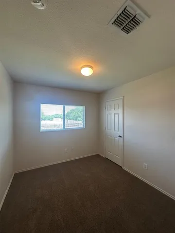 an empty room with windows and entrance