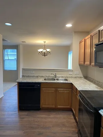 a kitchen with stainless steel appliances granite countertop a sink and stove top oven
