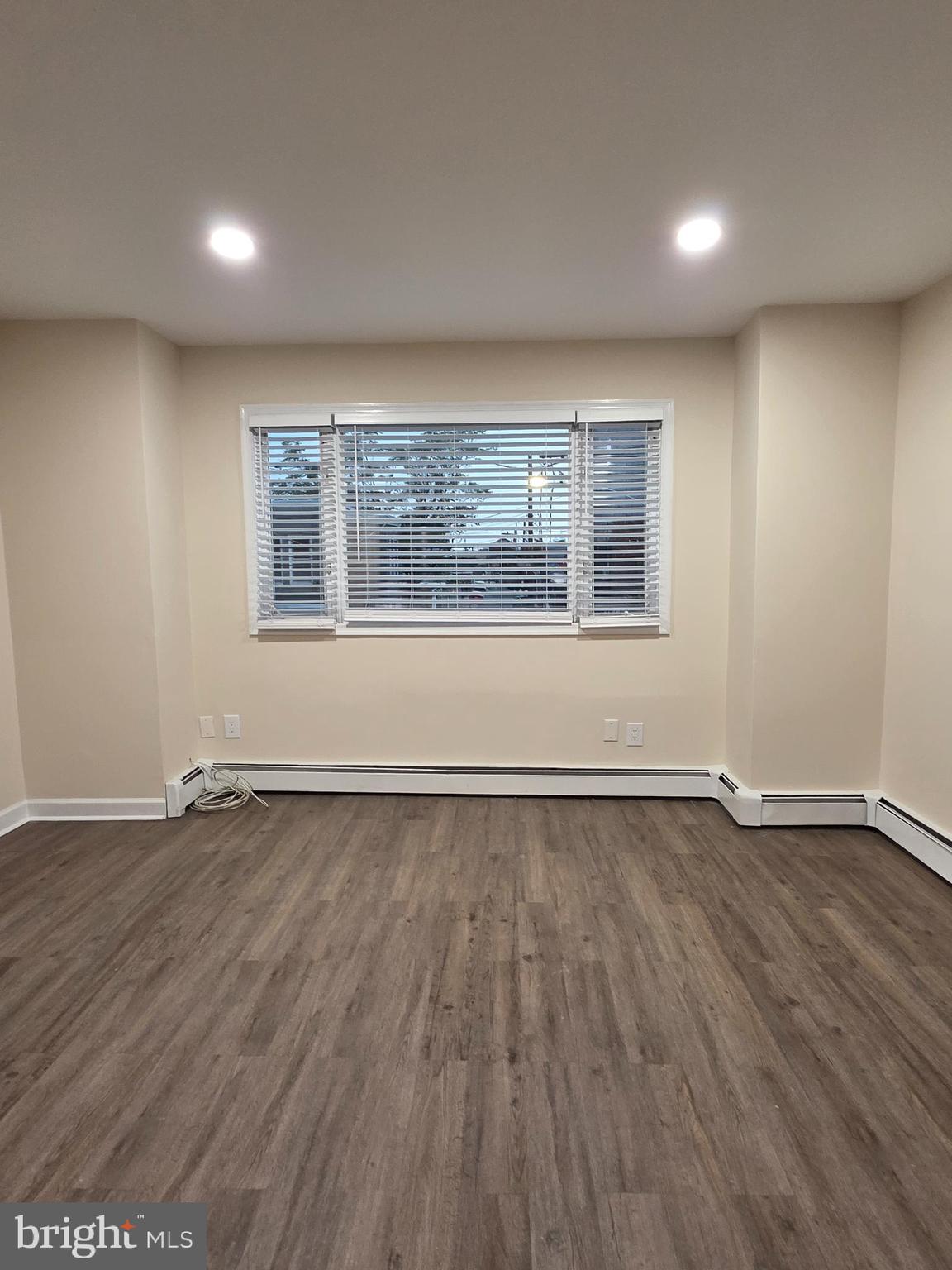 2715 East Ontario Street, Unit C Philadelphia, PA 19134 - Photo 13 of 32 an empty room with wooden floor and windows